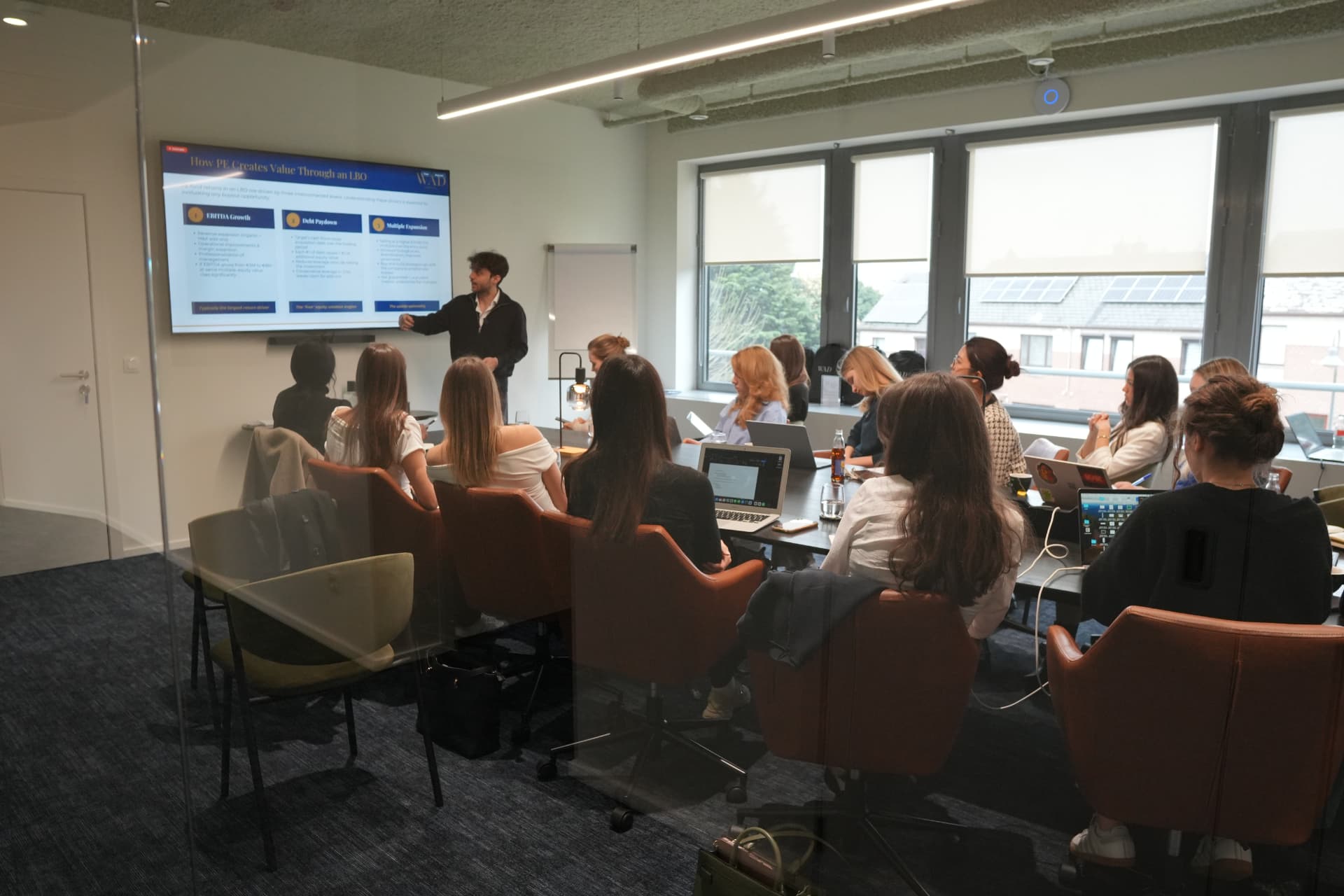 Herspective members in a workshop session with a presenter at a screen